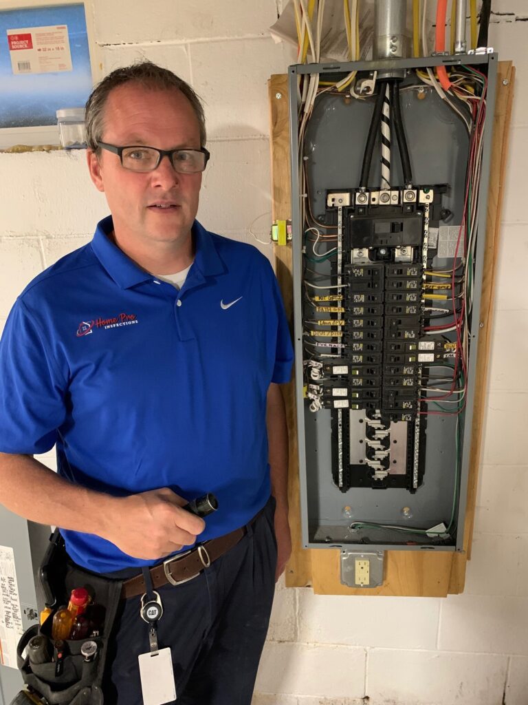 About - Employee posing near electrical fuse box